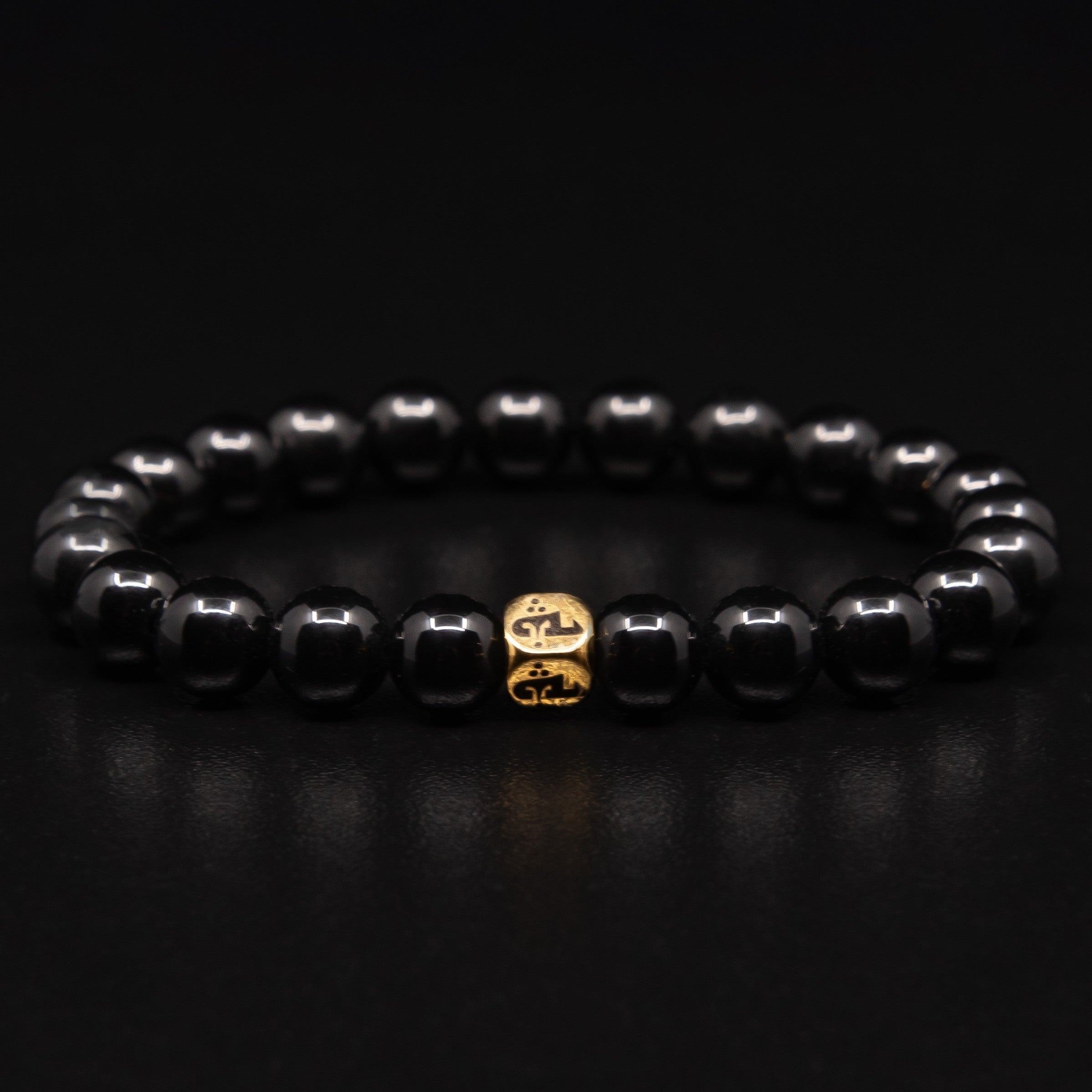 POLISHED BLACK ONYX BRACELET WITH GOLD TRINITY BEAD